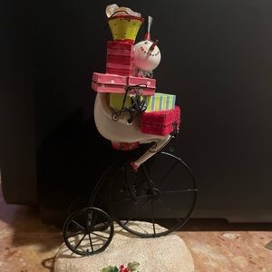 Snowman balancing presents on penny-farthing Christmas decor